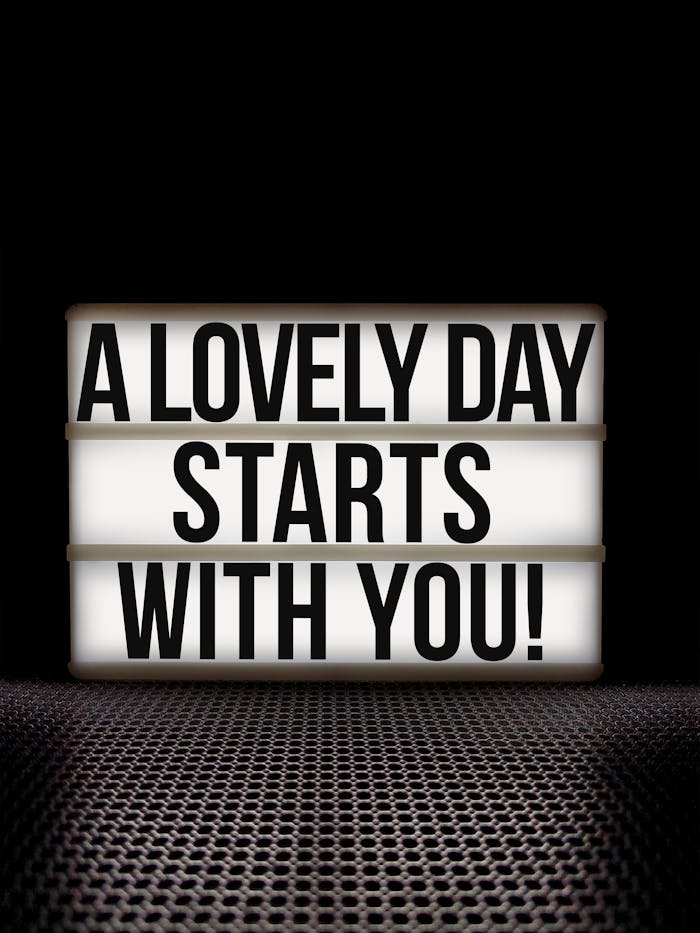 services-03 A motivational message on a lightbox against a black background, promoting positivity and empowerment.