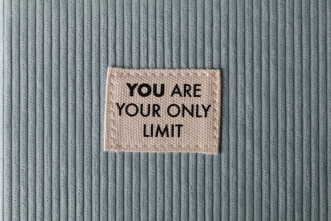our-story Fabric patch on blue velvet with motivational text 'You Are Your Only Limit' in close-up view.
